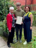 Alfie Grant is presented with the Tony Field Award by Rotarian Maggie Saunders and Lucie Larke the Operations Manager  of the Melton Learning Hub.